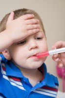Boy being given medicine
